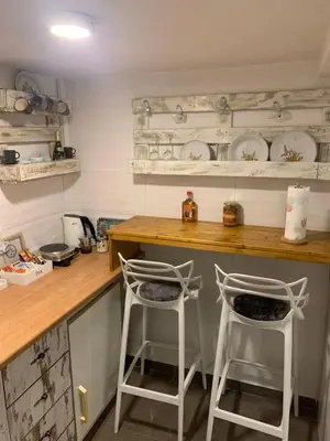 two white stools sitting at a counter in a kitchen at Apartman Nina BANOVO BRDO in Belgrade