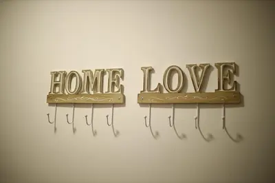 two metal signs with the words home and love at Apartman Lux in Nova Pazova