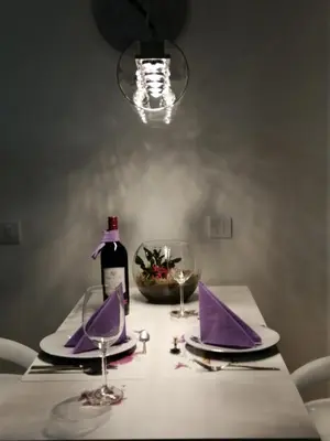 a table with purple napkins and a bottle of wine at Apartman Lux in Nova Pazova
