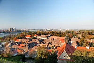 an aerial view of a town with buildings and a river at Hotel Novella Uno in Novi Banovci