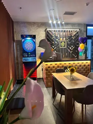 a dining room with a table and a blue screen at Luxury Apartments 88 in Smederevo
