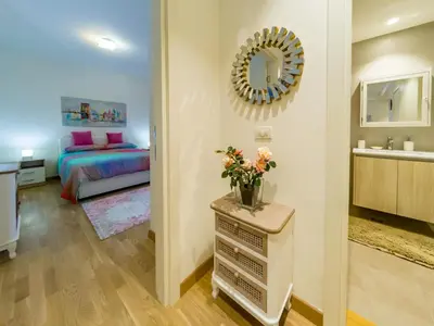 a bedroom with a bed and a mirror on the wall at Apartment Rebecca in Belgrade