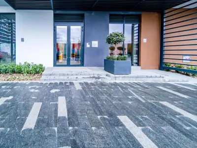 an empty parking lot in front of a building at Apartment Rebecca in Belgrade