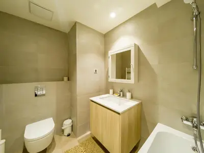 a bathroom with a sink and a toilet and a tub at Apartment Rebecca in Belgrade