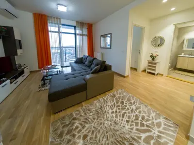 a large living room with a couch and a television at Apartment Rebecca in Belgrade