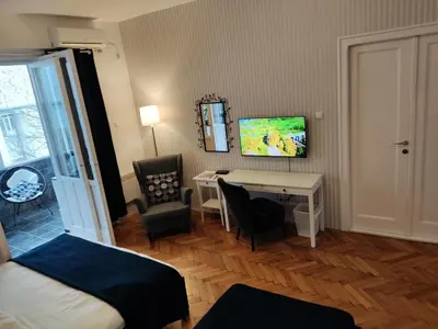 a room with a desk and a bed and a table at Selection Rooms in Belgrade