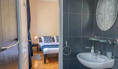 a bathroom with a sink and a mirror at Selection Rooms in Belgrade