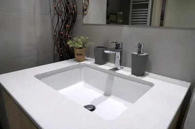a white sink in a bathroom with a mirror at Belgrade Waterfront Comfortable Apartment in Belgrade