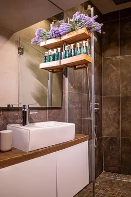 a bathroom with a white sink and a mirror at VENUS Apartment with jacuzzi and sauna - City Center in Belgrade