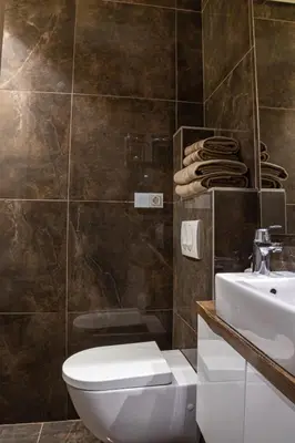 a bathroom with a white toilet and a sink at VENUS Apartment with jacuzzi and sauna - City Center in Belgrade