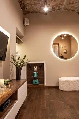 a living room with a round mirror and a couch at VENUS Apartment with jacuzzi and sauna - City Center in Belgrade