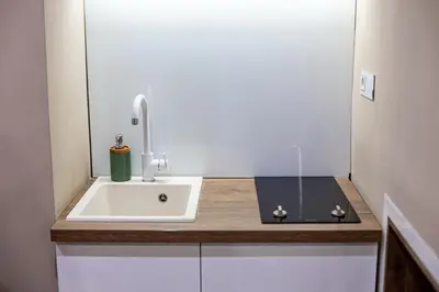 a bathroom with a sink and a book on a counter at VENUS Apartment with jacuzzi and sauna - City Center in Belgrade