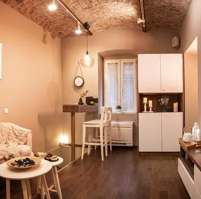a kitchen and living room with a table and chairs at VENUS Apartment with jacuzzi and sauna - City Center in Belgrade