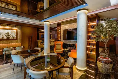 a lobby of a hotel with tables and chairs at Nobel Gallery Hotel in Belgrade