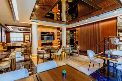 a restaurant with tables and chairs and a bar at Nobel Gallery Hotel in Belgrade