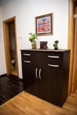 a bathroom with a dresser with a picture on the wall at The Temple bells, flat in the heart of the city in Dušanovac (historical)