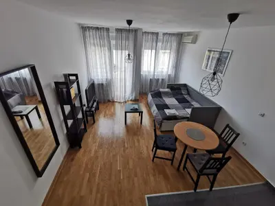 an aerial view of a living room with a table and chairs at Charlie Aviv Park in Belgrade