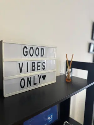 a sign that says good vibes only on a desk at Charlie Aviv Park in Belgrade