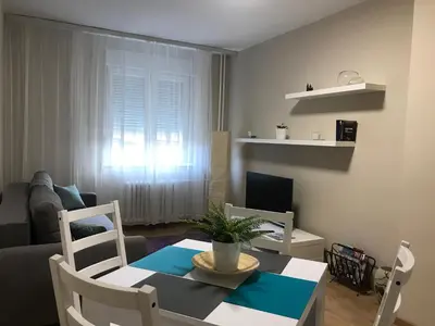 a living room with a table and chairs and a couch at TD City Center Apartment in Belgrade
