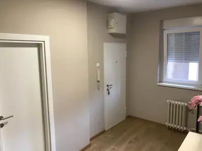 an empty room with a door and a window at TD City Center Apartment in Belgrade