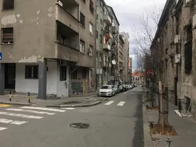 an empty city street with a white car parked on the street at TD City Center Apartment in Belgrade
