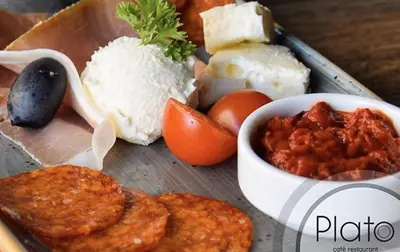 a tray of food with meat and a bowl of food at Teanna Lux Apartments in Belgrade