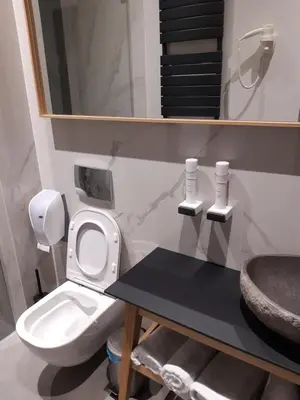 a bathroom with a white toilet and a sink at Teanna Lux Apartments in Belgrade