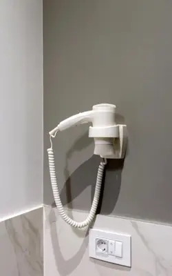 a white phone is hanging on a wall at Teanna Lux Apartments in Belgrade