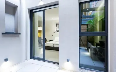 a room with sliding glass doors leading to a bedroom at Teanna Lux Apartments in Belgrade