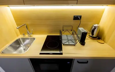 a kitchen with a sink and a counter top with a stove at Teanna Lux Apartments in Belgrade