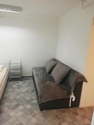 a bed with two pillows on it in a room at Apartman Pocerac in Belgrade