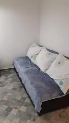 a bed with two pillows on it in a room at Apartman Pocerac in Belgrade