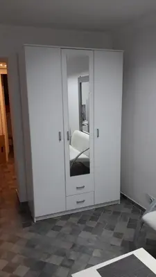 a room with a white cabinet with a mirror at Apartman Pocerac in Belgrade