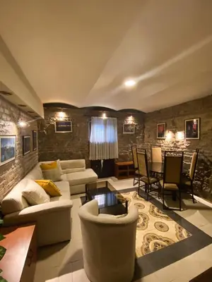a living room with couches and a table and chairs at Apartments HOUSE OF THE GREATS Skadarlija in Belgrade
