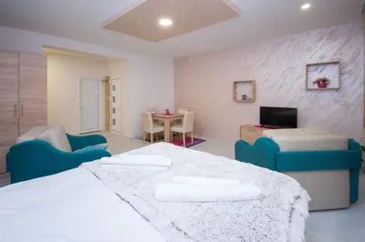 a room with a bed and chairs and a table at Cvetni trg in Belgrade