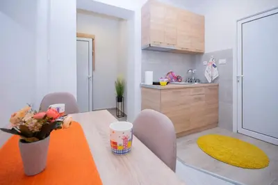 a kitchen with a table with a vase of flowers on it at Cvetni trg in Belgrade