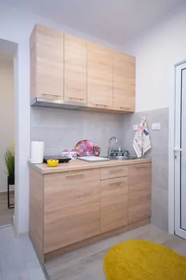 a kitchen with wooden cabinets and a sink at Cvetni trg in Belgrade