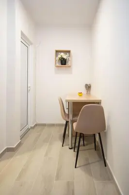 a dining room with a table and two chairs at Cvetni trg in Belgrade