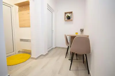 a small dining room with a table and chairs at Cvetni trg in Belgrade