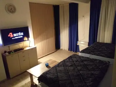 a hotel room with a bed and a flat screen tv at Skadarska Blue in Belgrade