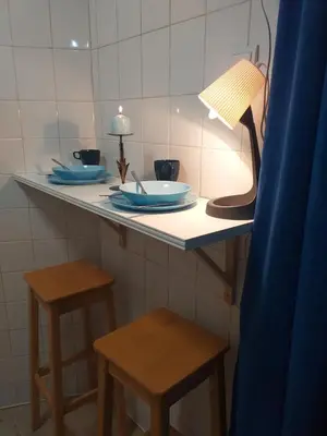a counter with blue plates and stools in a room at Skadarska Blue in Belgrade