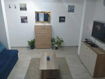 a living room with a couch and a tv and a table at Skadarska Blue in Belgrade