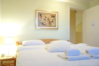 a bedroom with two beds with towels on them at Villa Quantum Beograd in Belgrade