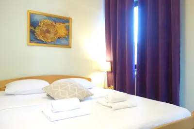 a bedroom with a bed with white towels on it at Villa Quantum Beograd in Belgrade