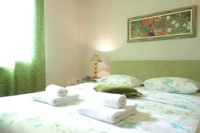 a bedroom with a bed with towels on it at Villa Quantum Beograd in Belgrade