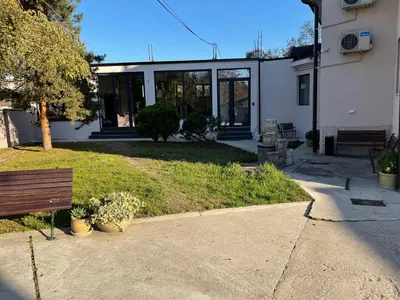 a house with a bench in front of a building at Villa Quantum Beograd in Belgrade