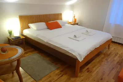 a bedroom with a large bed with two towels on it at Villa Quantum Beograd in Belgrade