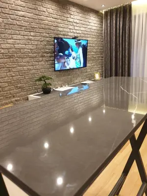 a large tub in a room with a tv on a brick wall at Luxury Spa Suite in Belgrade