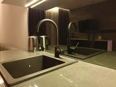 a kitchen with a sink and two faucets at Luxury Spa Suite in Belgrade