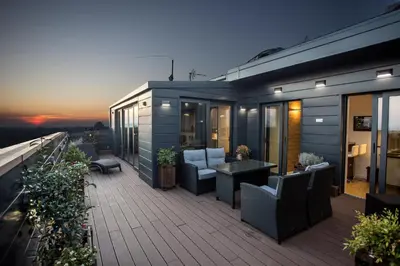a balcony of a house with chairs and a table at Penthouse Lux in Belgrade